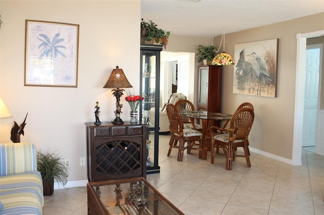 dining area featuring baseboards and light tile patterned floors