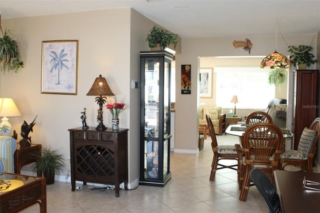 living area featuring light tile patterned floors and baseboards