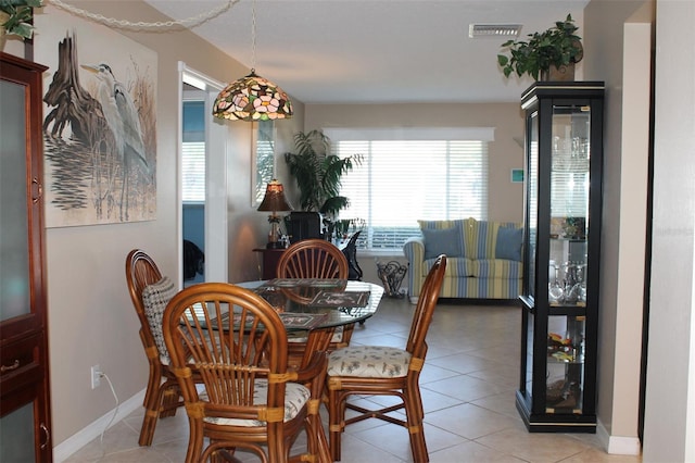 dining area with visible vents, baseboards, and light tile patterned floors