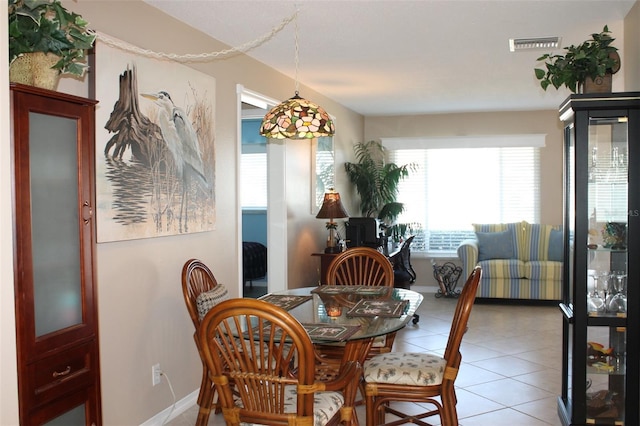 dining space with baseboards, visible vents, and tile patterned floors