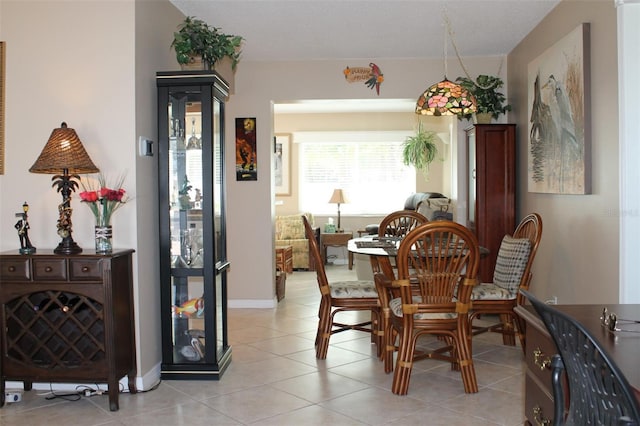 dining room featuring light tile patterned floors and baseboards