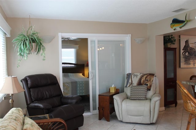 sitting room featuring light tile patterned floors and visible vents