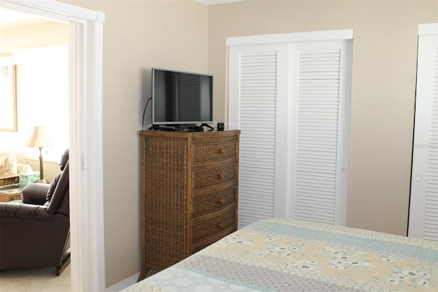 tiled bedroom featuring a closet