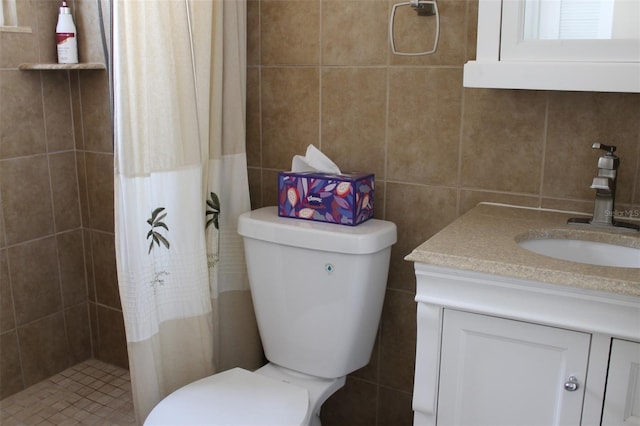 bathroom featuring toilet, vanity, tile walls, and tiled shower