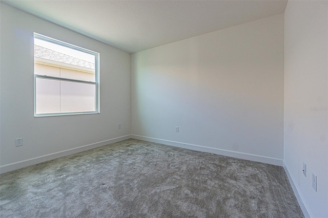 empty room with carpet flooring and baseboards