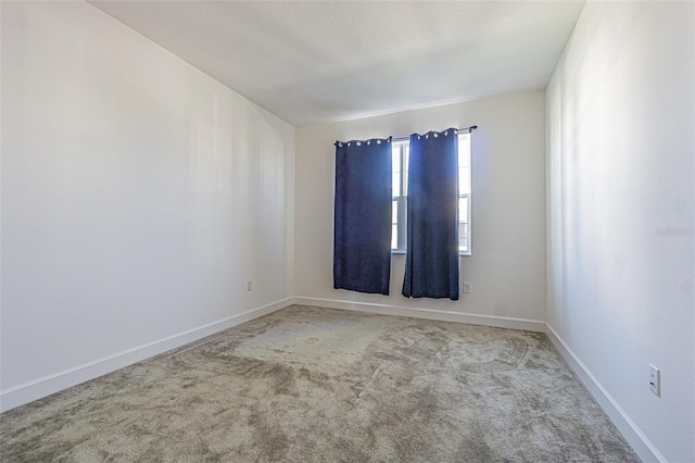 spare room with carpet flooring and baseboards