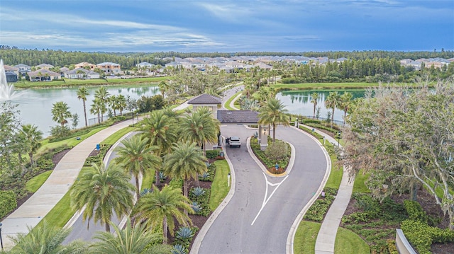 birds eye view of property with a residential view and a water view