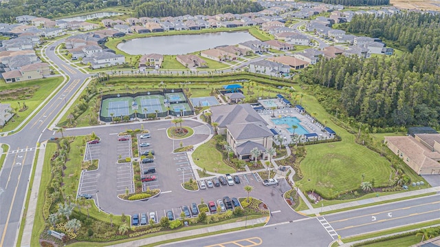 birds eye view of property with a water view and a residential view