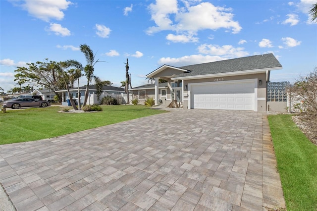 ranch-style house featuring a garage, decorative driveway, a front lawn, and stucco siding