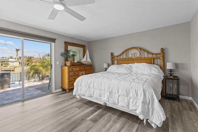 bedroom with access to outside, ceiling fan, baseboards, and wood finished floors