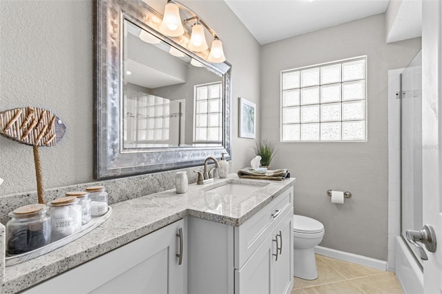 full bath with toilet, vanity, baseboards, and tile patterned floors