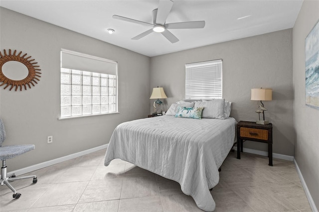 bedroom with a ceiling fan, baseboards, and light tile patterned floors