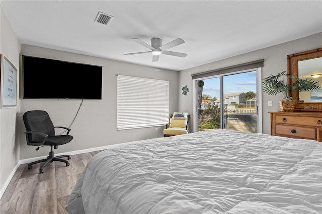 bedroom with baseboards, visible vents, ceiling fan, wood finished floors, and access to outside