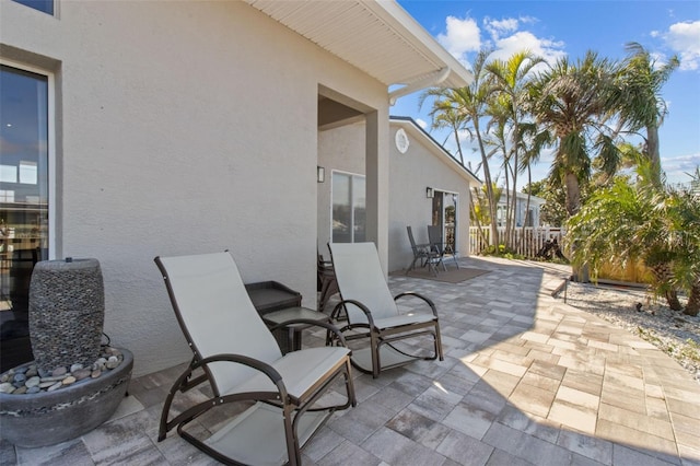 view of patio featuring fence