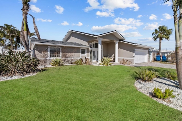 view of front of home featuring a front yard, decorative driveway, an attached garage, and stucco siding