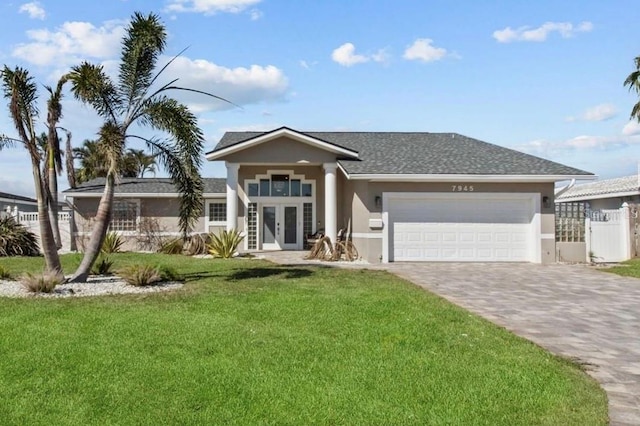 view of front of house featuring stucco siding, an attached garage, fence, decorative driveway, and a front yard