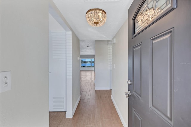 interior space with light wood finished floors, visible vents, and baseboards