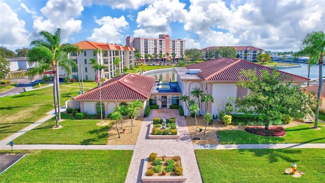 exterior space with a water view, a tile roof, and stucco siding