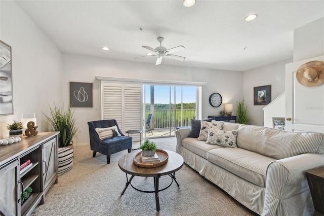 living area featuring light carpet, ceiling fan, and recessed lighting