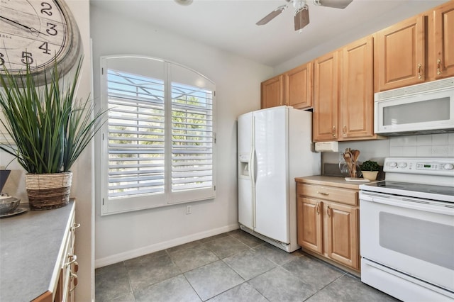kitchen featuring white appliances, light countertops, ceiling fan, and baseboards