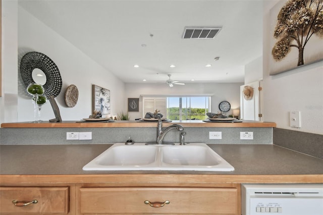 kitchen featuring ceiling fan, white dishwasher, recessed lighting, a sink, and visible vents