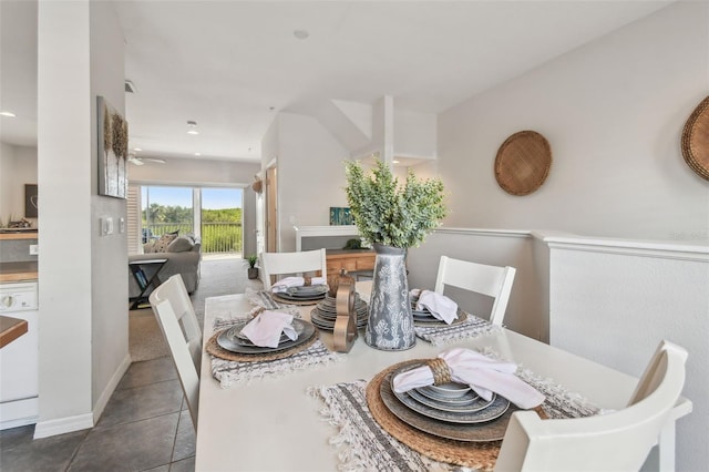 dining space featuring dark tile patterned flooring