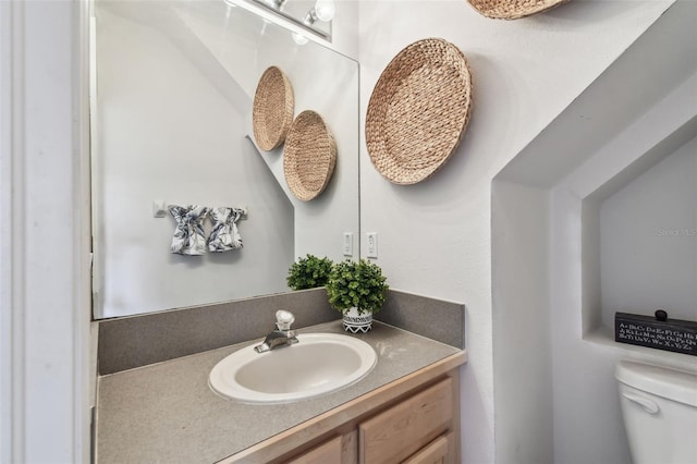 half bath with vanity and toilet