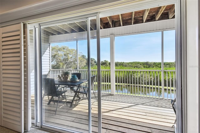 doorway to outside with a water view