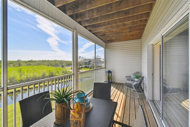 sunroom / solarium with a water view