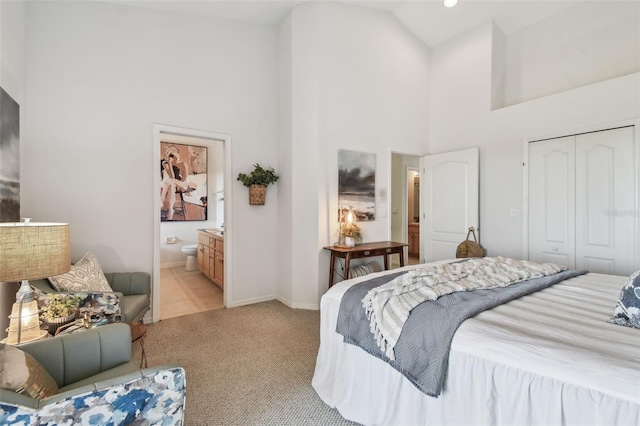 bedroom with high vaulted ceiling, a closet, light colored carpet, and baseboards