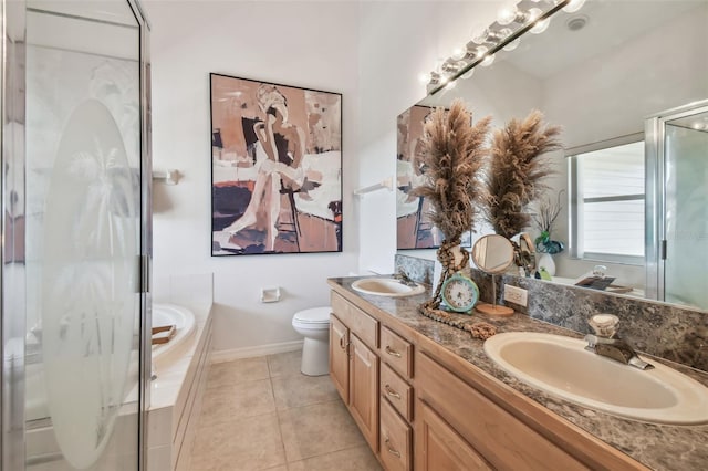 full bathroom with toilet, a garden tub, a sink, and tile patterned floors