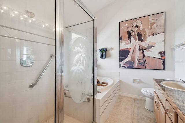 bathroom featuring toilet, vanity, a shower stall, tile patterned flooring, and a bath