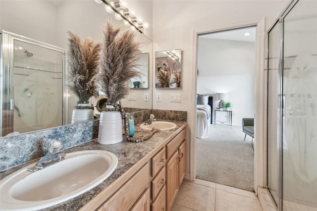 full bathroom featuring ensuite bathroom, tile patterned floors, a sink, and a shower stall