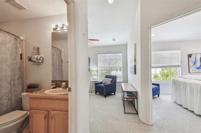 full bath featuring ceiling fan, connected bathroom, toilet, visible vents, and vanity