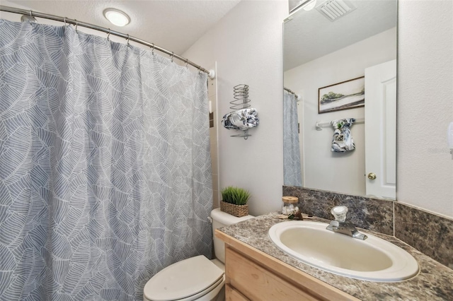 full bathroom with toilet, visible vents, and vanity