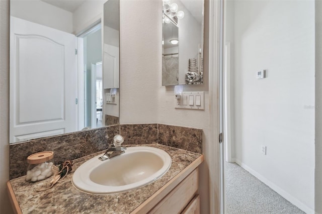 bathroom with vanity and baseboards