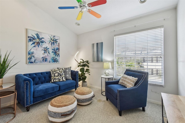 carpeted living area featuring a ceiling fan, lofted ceiling, and baseboards