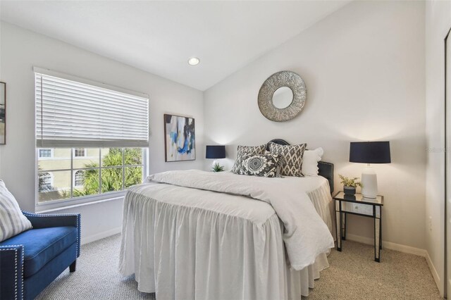 bedroom featuring vaulted ceiling, recessed lighting, light carpet, and baseboards