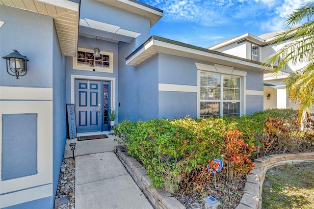 property entrance with stucco siding