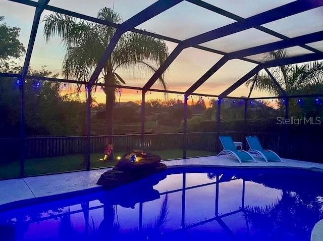 pool with a lanai and a patio