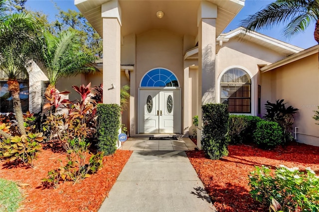 entrance to property featuring stucco siding