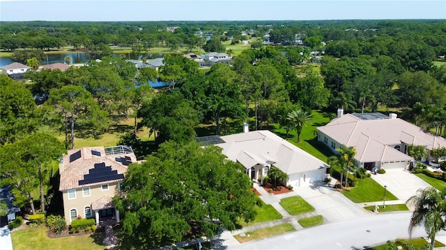 drone / aerial view with a water view and a forest view
