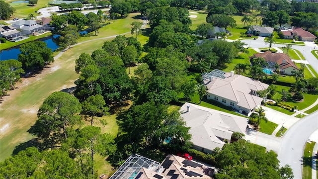 aerial view with view of golf course, a water view, and a residential view