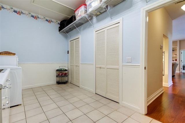 storage area featuring attic access, washer / dryer, and visible vents