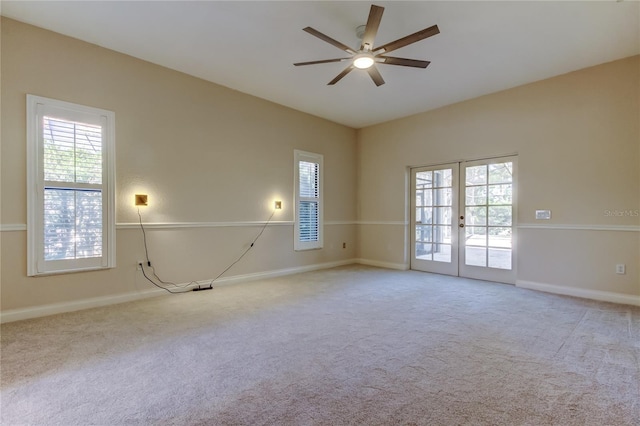 spare room with ceiling fan, french doors, carpet flooring, and a wealth of natural light