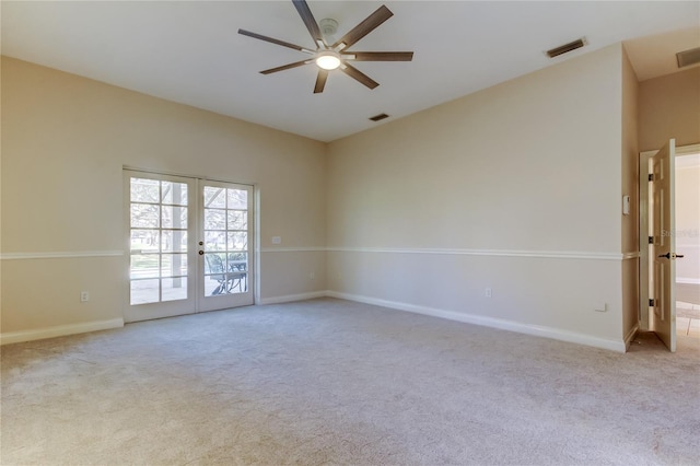 spare room featuring carpet, french doors, and visible vents