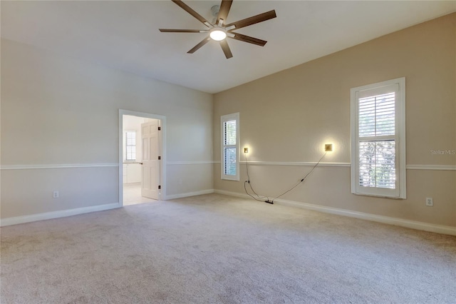 unfurnished room featuring baseboards, a ceiling fan, and light colored carpet