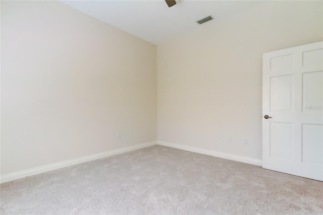 unfurnished room featuring light colored carpet, visible vents, ceiling fan, and baseboards