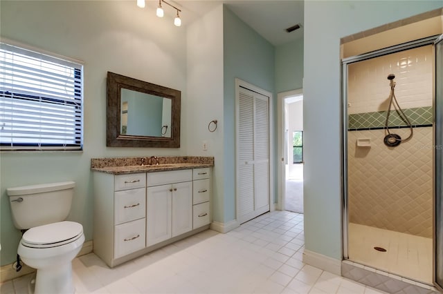 full bath with a stall shower, baseboards, visible vents, toilet, and vanity