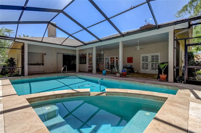 view of pool featuring a ceiling fan, a lanai, french doors, a patio area, and a pool with connected hot tub